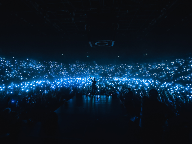 Flash lights in an arena concert, stage view to crowd